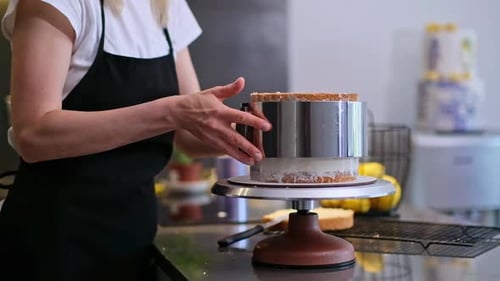 Cake Creation with Frosting and Metal Form