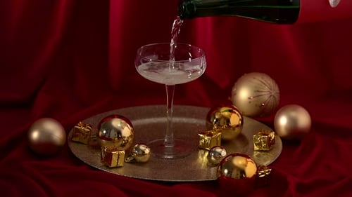 Pouring champagne in a glass.