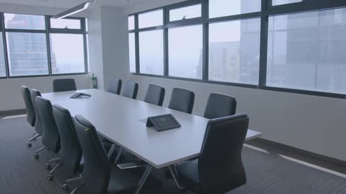 Panning Shot Of A Stylish And Modern Meeting Room In A Corporate Office With Buildings Outside View