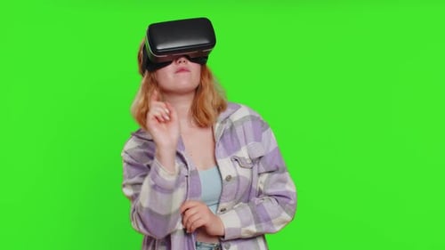 Woman Experiencing Virtual Reality with Headset on Green Screen