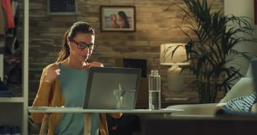 Woman Video Conferencing at Home on her Laptop