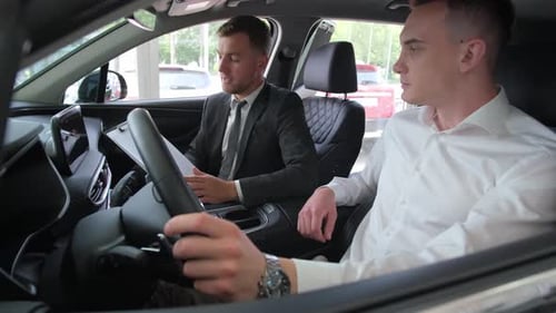 Car Salesman Explaining Vehicle Features to Customer