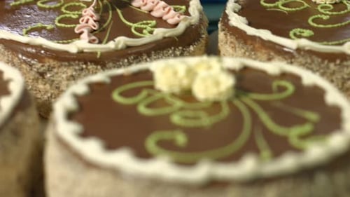 Decorating Chocolate Cakes with Icing in a Bakery