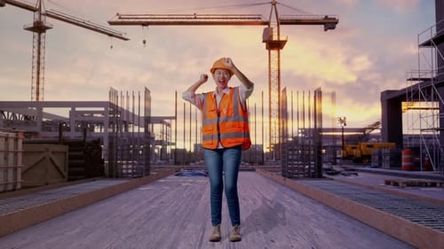 Full Body Of Asian Female Engineer Screaming Goal And Dancing Celebrating at Construction Site