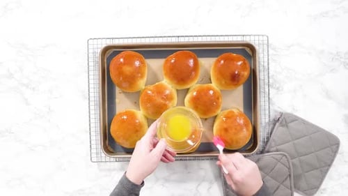 Glazing Fresh Baked Buns with Butter