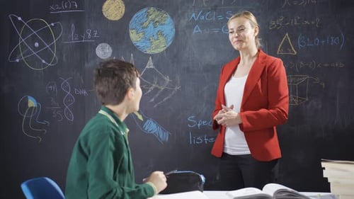 Student Discussing Math with Teacher in Classroom