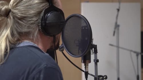 Condenser microphone and singer, back view, close up