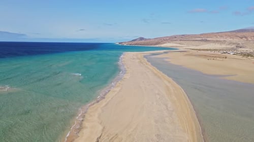 Flying over the ocean and sand beach with drone.