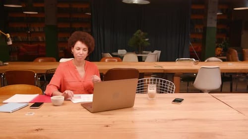Successful Colleagues Sitting on Table in Modern Office Using Laptop Working Planning Project