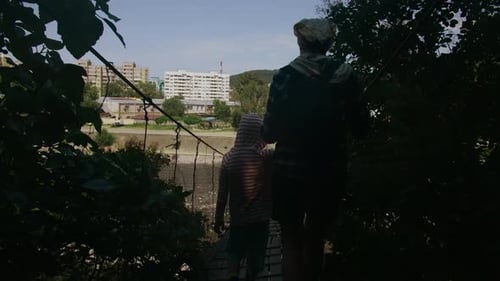 Mother and Child Walk on Wooden Bridge Creative Rear View of Mother and Child Coming Out of Forest
