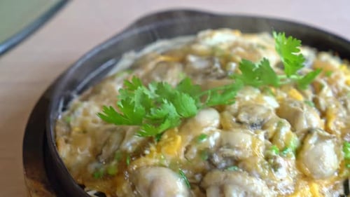 Oyster omelette with bean sprout on hot pan - Asian food style