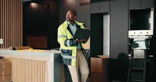 Laptop, planning and real estate with black man in kitchen for home improvement or upgrade project