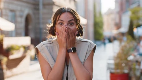Young Woman Looking Surprised at Camera Shocked By Sudden Win Good Victory News Wow in City Street