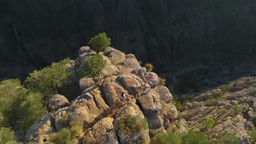 Aerial View Friends Posing on the Edge of a Beautiful Canyon in Turkey