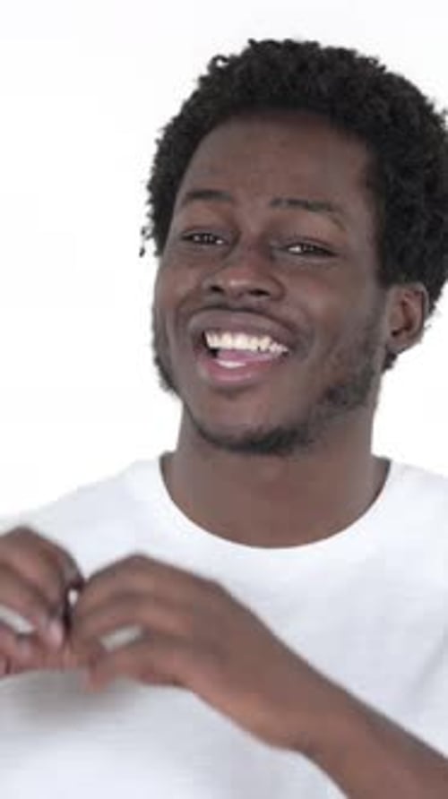 Smiling Young Man Making a Heart Shape With Hands
