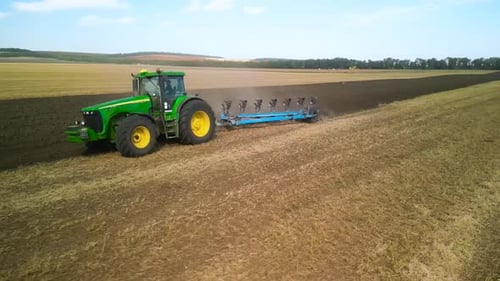 Tractors plowing the field in Ukraine
