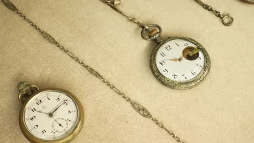 Antique Pocket Watches on Tan Background