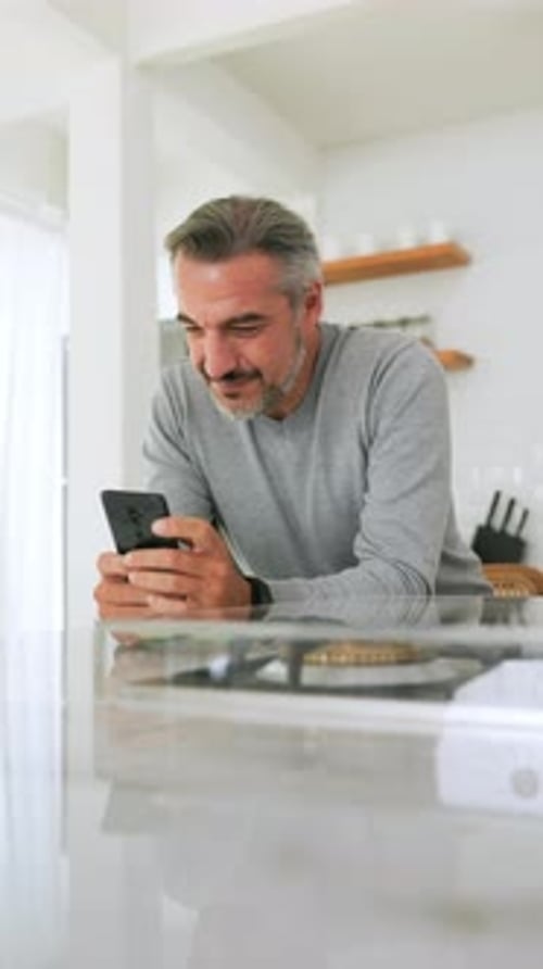 Man Uses Smartphone in Bright Home