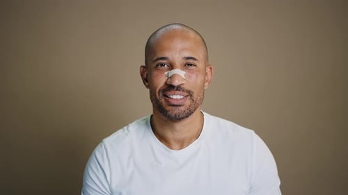 Adult Smiling with Bandage on Nose