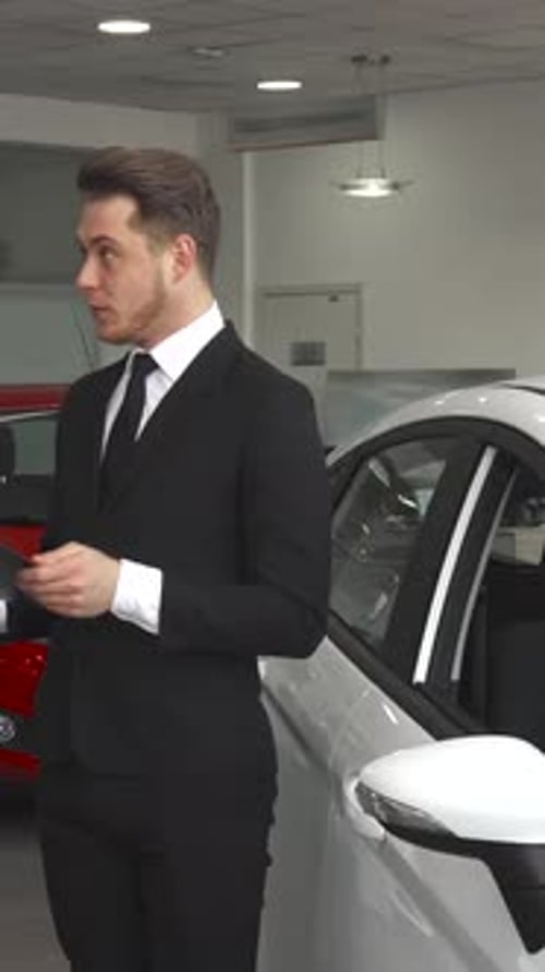 Sales Manager Passionately Explains Contract Details to a Customer at the Car Dealership