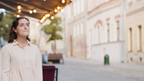 Woman Runs Late on a Cobblestone Street