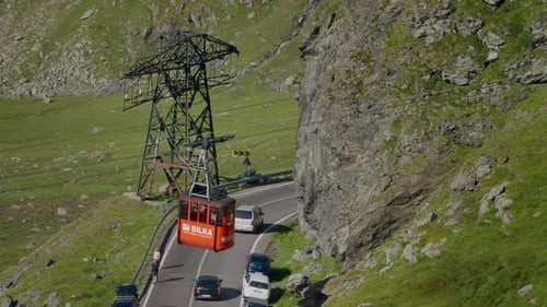 Cable car with cabins on the outskirts of mountain.