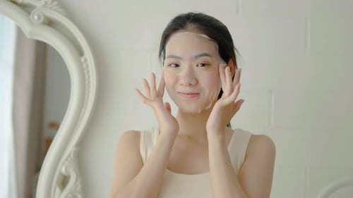 Young Adult Applying a Facial Mask at Home