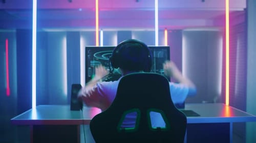 Gamer Celebrating Victory in Neon Lit Room