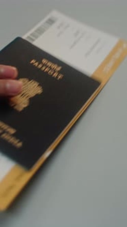 Close Up of Passenger Putting Indian Passport with Airplane Ticket on Airport Checkin Counter