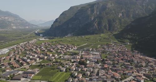 Aerial view of town and vineyards among mountains, Italy.