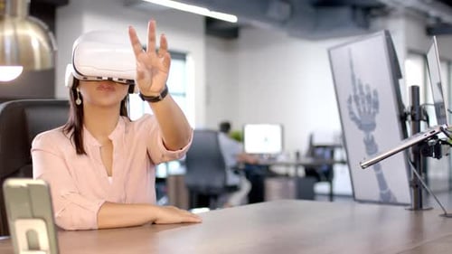 Using VR headset, woman interacting with virtual interface in modern office, copy space
