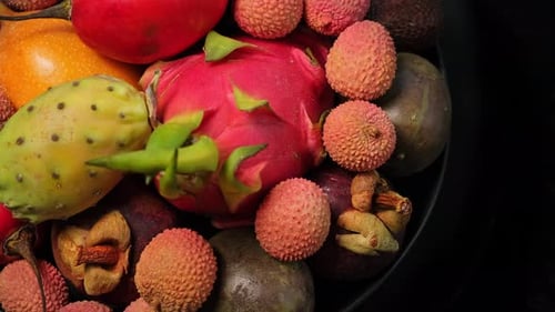 Exotic fruit rotation background. Fresh tropical fruits rotate, close-up. Tropical Fruit