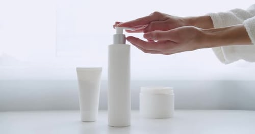 Woman Uses Lotion from Bottle, Pampering Routine
