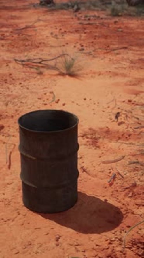 Old Empty Rusted Barrel on Sand