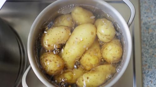Kartoffeln kochen derzeit in Wasser, perfekt vorbereitet zum Kochen oder zur weiteren Zubereitung von Mahlzeiten