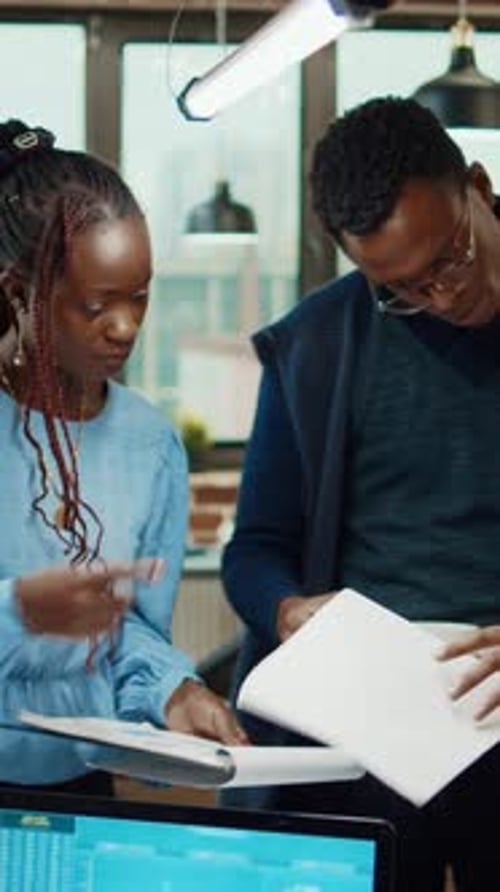Vertical Video Office Workers Examining Startup Results