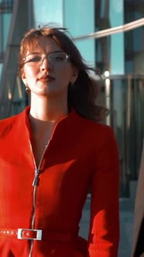 Stylish Woman in Red Suit Walks Past Man