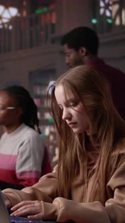 Vertical Video College Student Captivated By Literature Assignment at the Academic Library