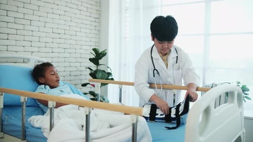 Two cute, diverse children role-playing as doctor and sick patient in uniform.