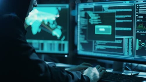 Hooded Person Typing at Computer Late at Night