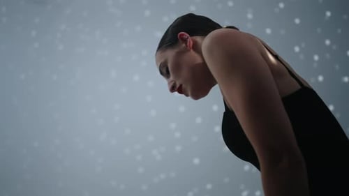 Woman Dances Expressively in Studio with Lighting Effects