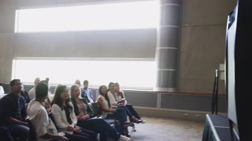 Audience listening to a presenter at a conference