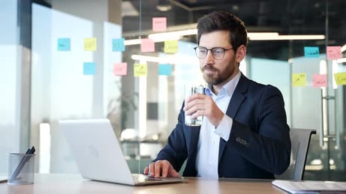 Man Types on Laptop at Modern Office Desk