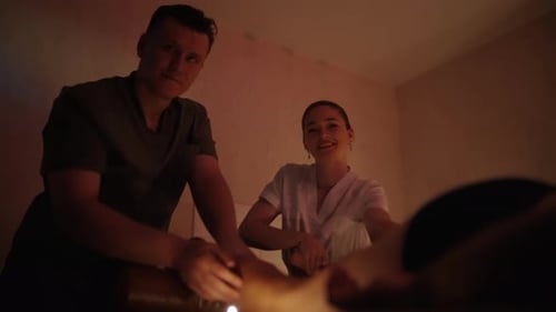Woman receiving massage in dimly lit room