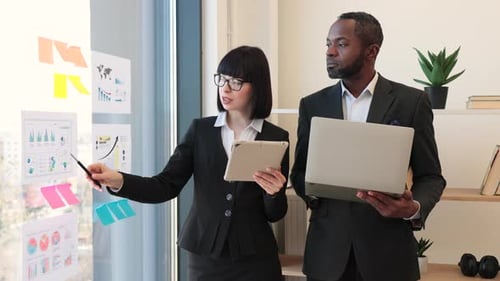 Enterpreneurs Working on Data with Modern Devices in Office