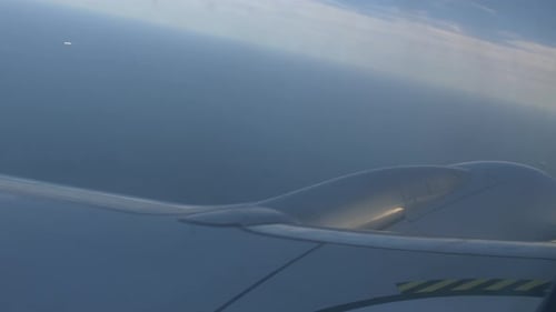 Airplane flying over the sea, engine view