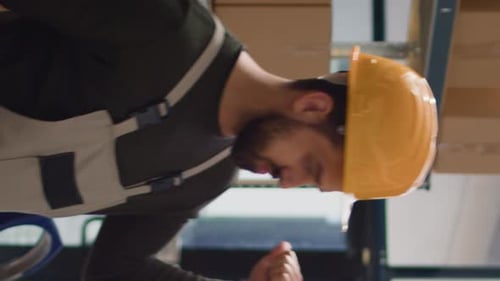 Vertical Video Warehouse Workers Analyzing Inventory