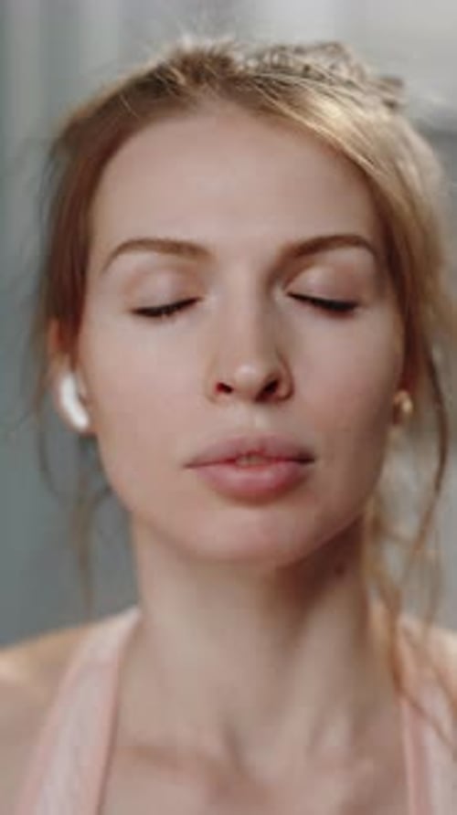 Woman Meditating Indoors in Workout Clothes, Eyes Closed