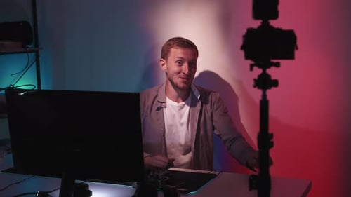 Man Talking to Camera at Computer Desk