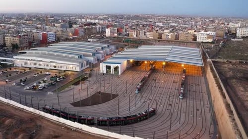 Drone shot of a tramway leaving the Tramway maintenance center in Casablanca